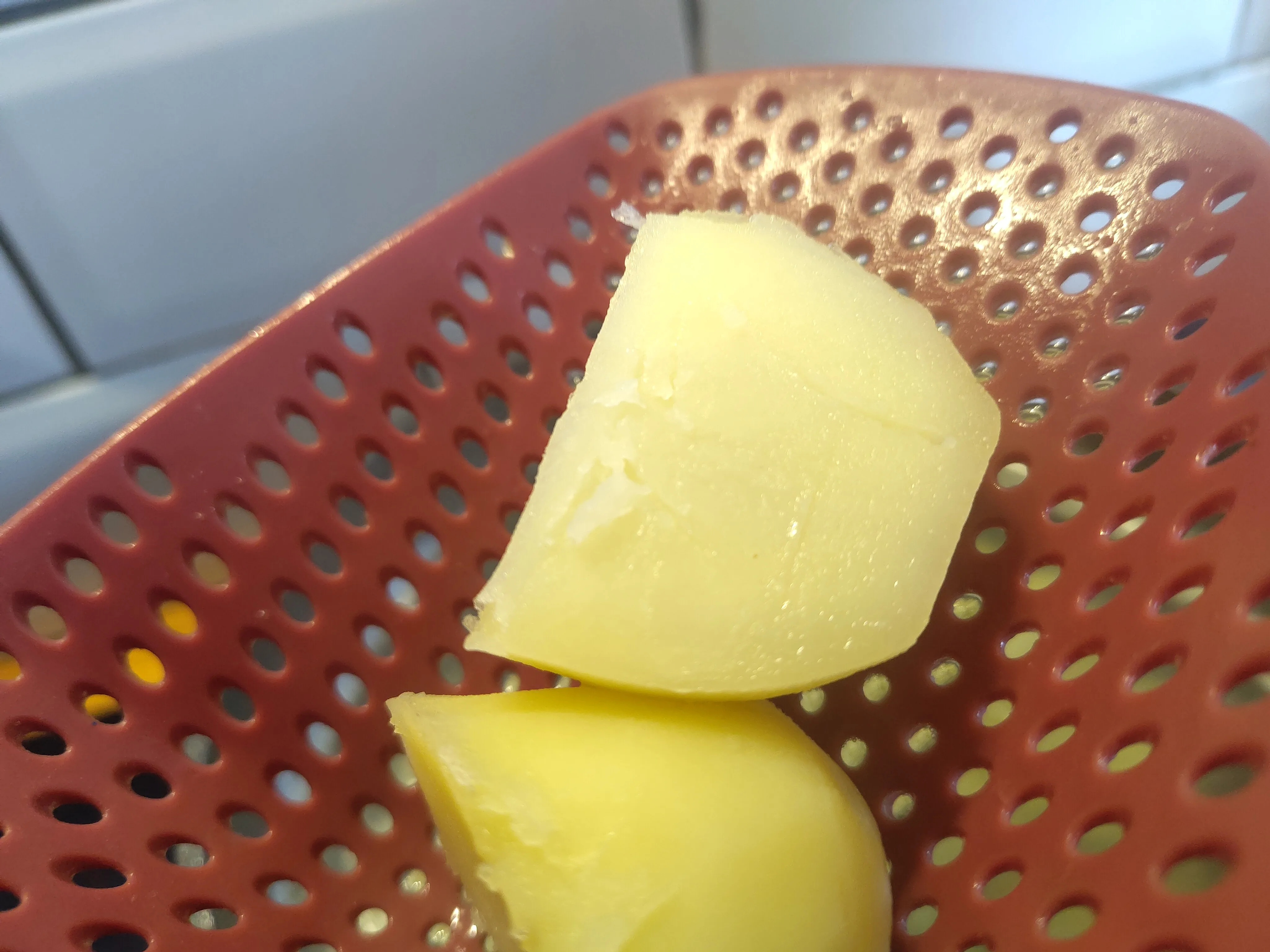 A parboiled potato with a mark from a fork