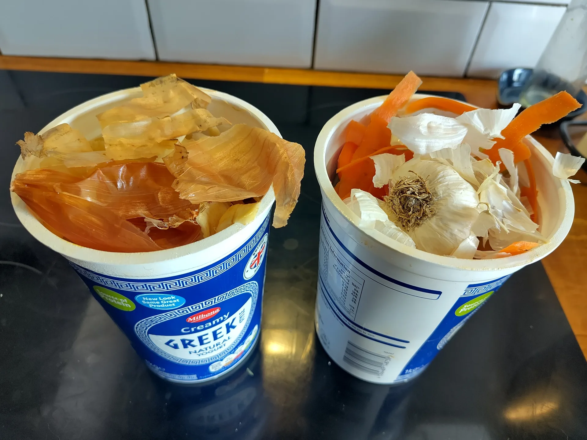 Vegetable trimmings in two yogurt pots